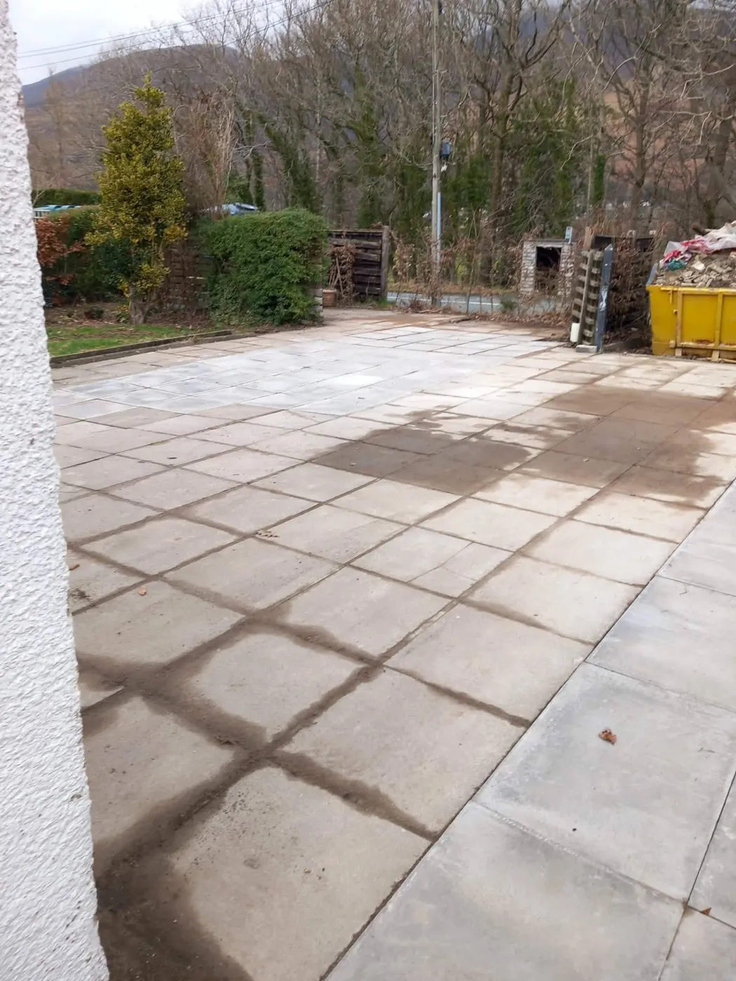 Concrete slab area part-way through pressure washing